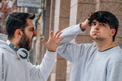 young people arguing in the street photo