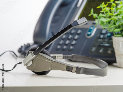 Close-up. Phone, fax and headphones. Isolated on white background. Office, work, communications, social sphere, remote work, freelance, business. There are no people in the photo. Banner.