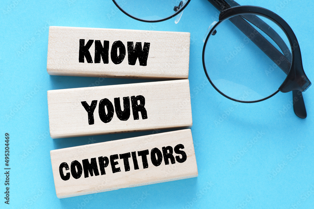 KNOW YOUR COMPETITORS text on wooden blocks, concept of business success. KNOW YOUR COMPETITORS text on wooden blocks, concept of business success.