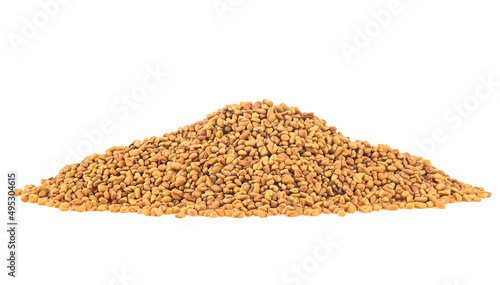 Pile of dried fenugreek seeds isolated on a white background photo