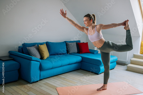 Woman in Lord of the dance yoga pose training at home