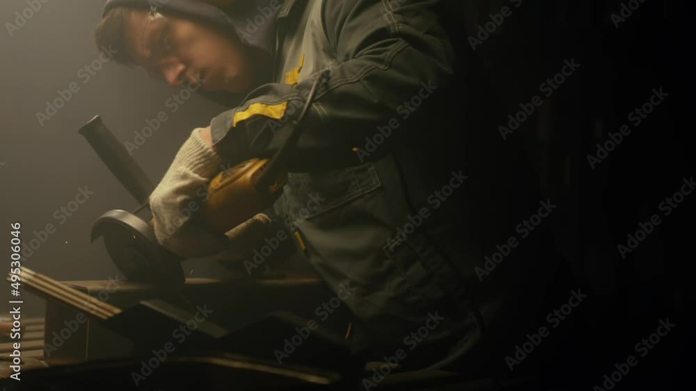 Industrial worker cutting metal with many sharp sparks. Male using special tool for cutting metal at workshop. Sparks flying from metal processing. Slow motion. 4K video. Shot on RED Industrial worker cutting metal with many sharp sparks. Male using special tool for cutting metal at workshop. Sparks flying from metal processing. Slow motion. 4K video. Shot on RED