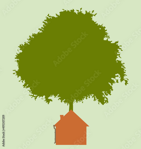 House on a green next to a tree. A flat one-color house, simple in shape. Sunny day