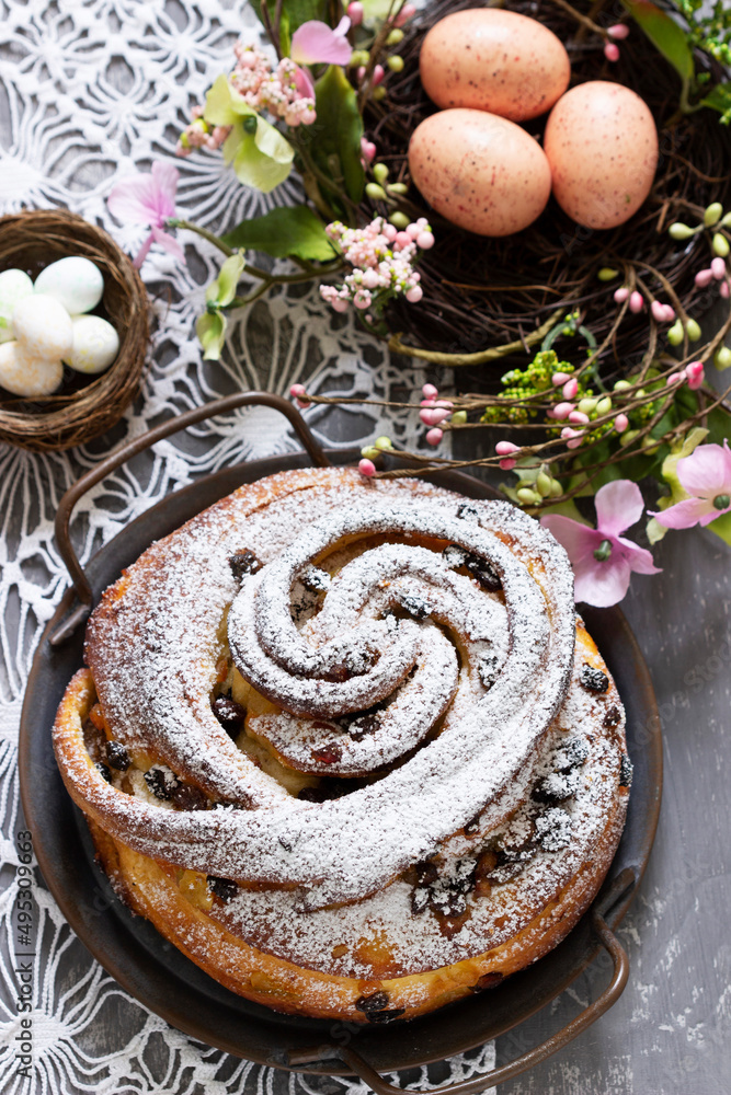 Easter cake with zest and dried fruits and Easter decor on a light background.
