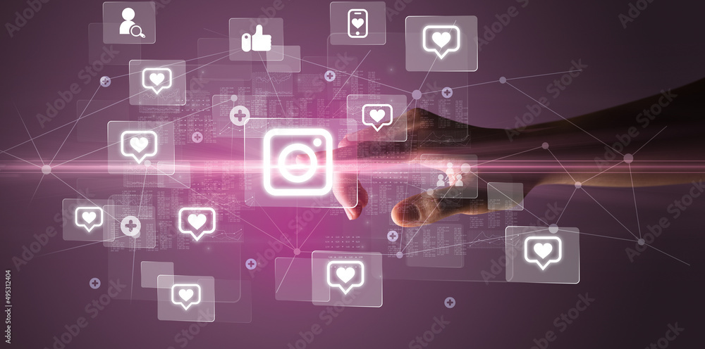 Hand pressing social media multimedia application screen with media icons on futuristic concept Hand pressing social media multimedia application screen with media icons on futuristic concept