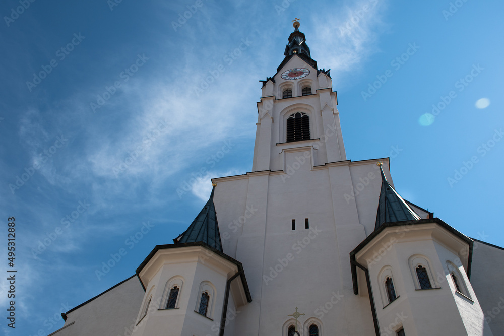 Mariä Himmelfahrt Church (Assumption of Mary Church) in the Bavarian town of Bad Tölz in Germany, seen from below, with the clock tower looking like a face