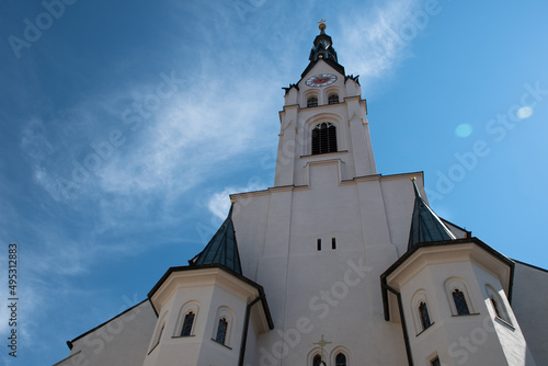 Mariä Himmelfahrt Church (Assumption of Mary Church) in the Bavarian town of Bad Tölz in Germany, seen from below, with the clock tower looking like a face