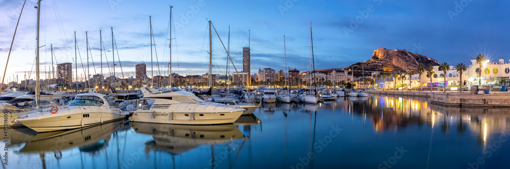 Alicante Port d'Alacant marina with boats and view of castle Castillo twilight travel traveling holidays vacation panorama in Spain