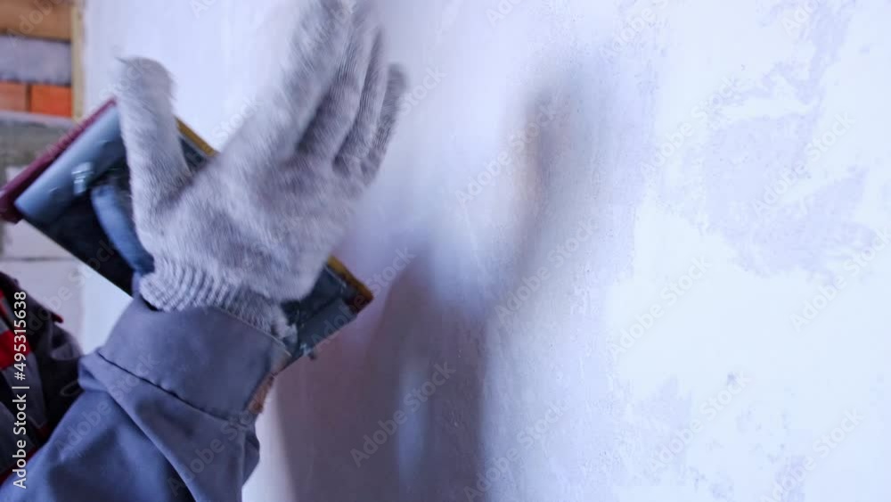 Sanding of walls with sandpaper after treatment with dry building mixes