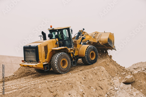 Dozer, excavator, and road rollers working on the mud site