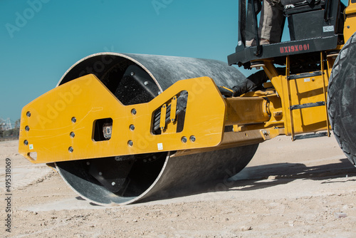 Dozer, excavator, and road rollers working on the mud site