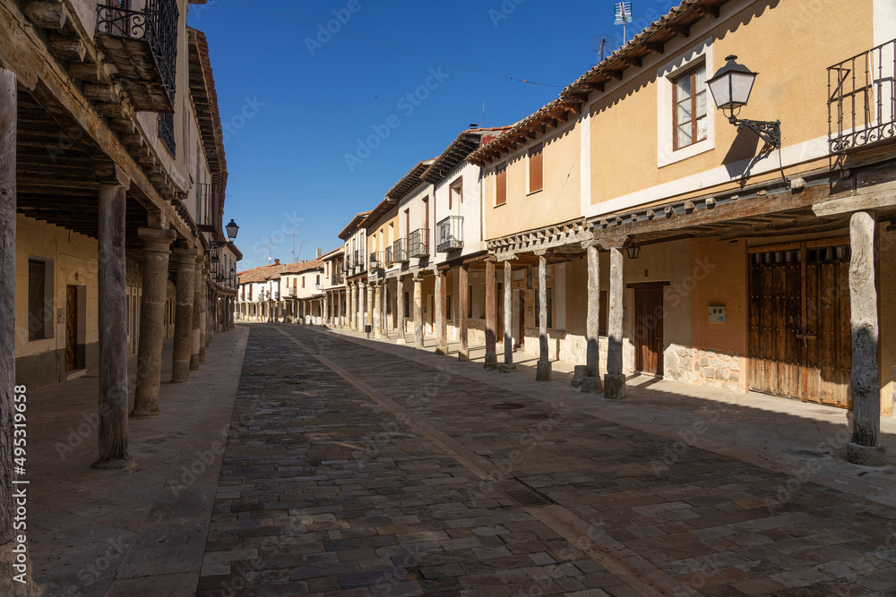 Streets with a traditional Castilian architecture with its houses with arcades in Ampudia, Palencia, Castilla y León, Spain.
