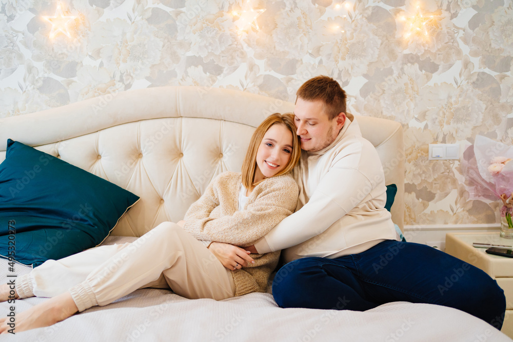 a happy and loving couple hugs on the bed a happy and loving couple hugs on the bed