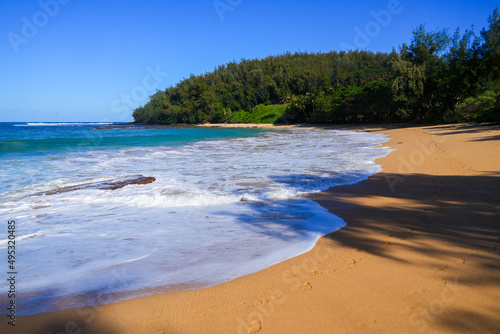 Fototapeta Naklejka Na Ścianę i Meble -  Waves of the Pacific Ocean on Moloa'a beach on the North Shore of Kauai island in Hawaii, United States