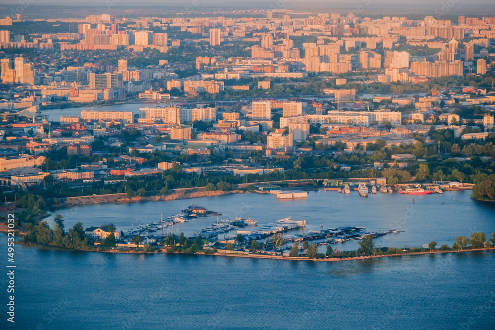 Panoramic summer shot from above of Kazan city. Capital of the Tatarstan, Russia. City centre and landmark. Residential buildings and attractions. Kazanka river, boats and yachts are parked.