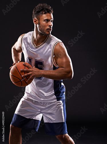 Got game. Studio shot of a basketball player against a black background. © Duncan M/peopleimages.com
