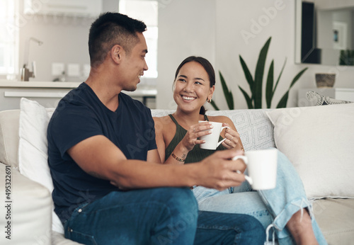 Chats over coffee are their thing. Shot of a young couple drinking coffee while relaxing together at home.