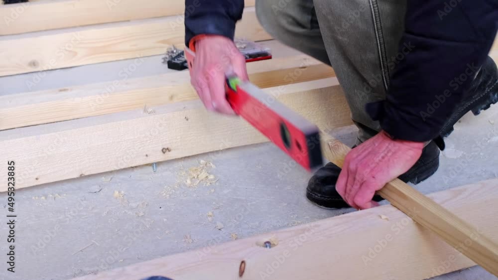 Installation of a wooden floor log on studs at the hydraulic level. Installation of the rough floor on the concrete floor of the house, repair of the house with your own hands, diy. Slow motion