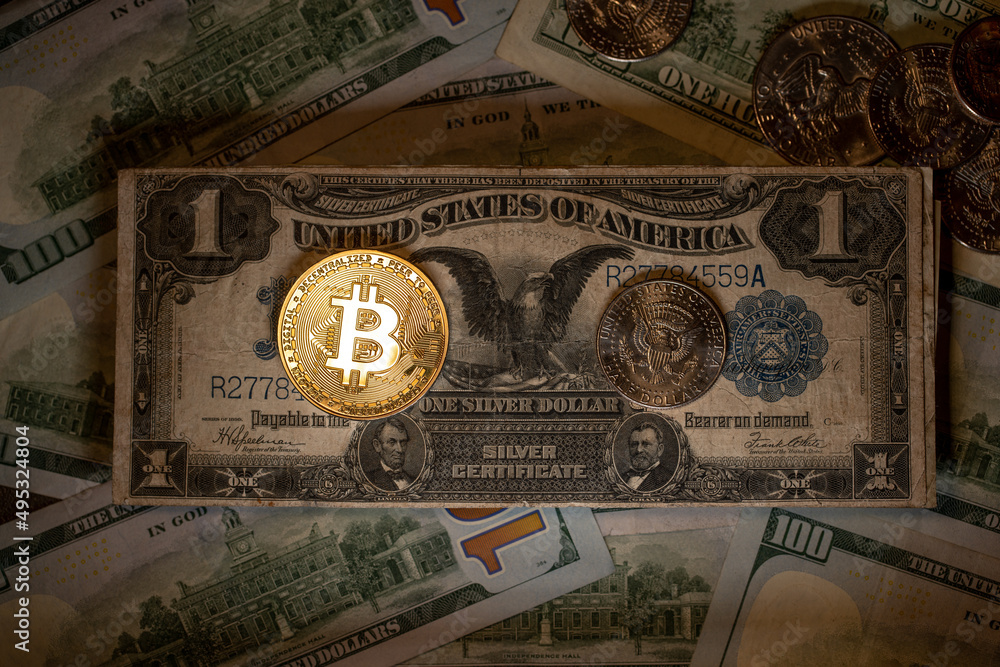 Shining Gold Bitcoin on Black Eagle Dollar banknote. Digital currency BTC