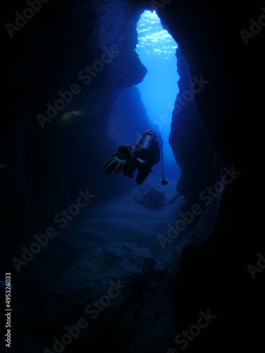 Wallpaper Mural cave diving underwater scuba divers exploring caves and having fun ocean scenery sun beams and rays background Torontodigital.ca