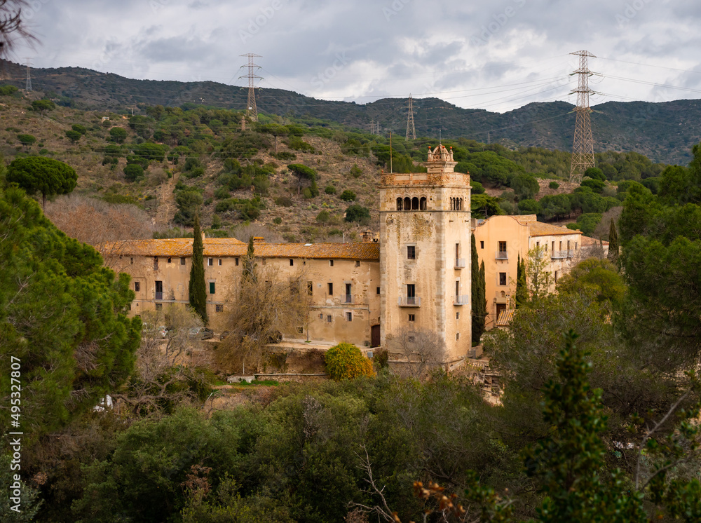 General view of ancient Catholic monastery of San Jeronimo de la Murtra on cloudy winter day in Sierra de la Marina natural area in municipality of Badalona, Catalonia, Spain