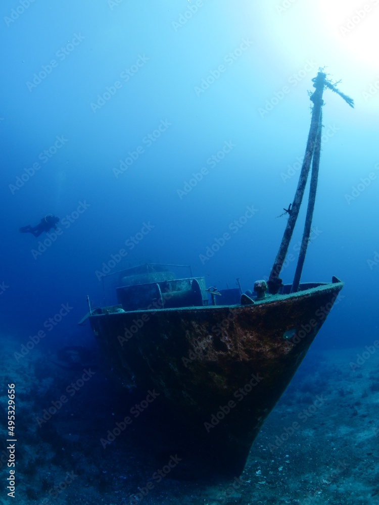 scuba divers exploring and discovering the ship wreck underwater deep sea bottom metal on ocean floor scuba divers exploring and discovering the ship wreck underwater deep sea bottom metal on ocean floor