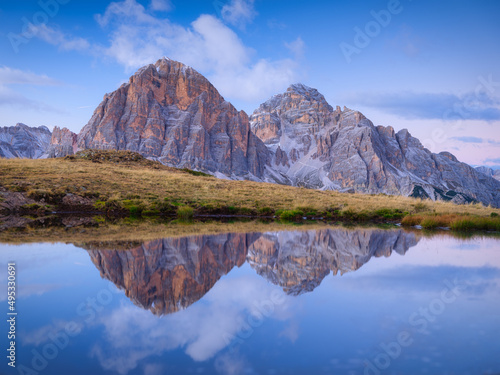 High mountains and reflection on the surface of the lake. Giau Pass, Dolomite Alps, Italy. Landscape in the highlands during sunset. Photo in high resolution.