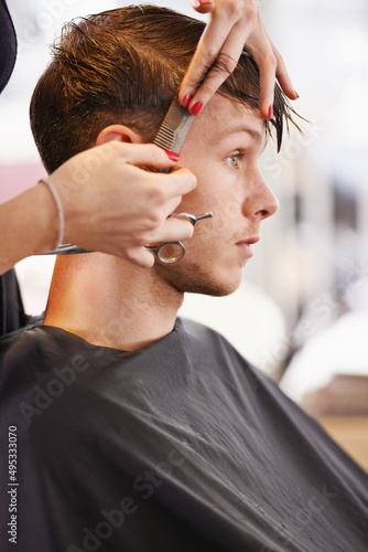 Serious style. Cropped shot of a young man having his hair cut by a stylist.