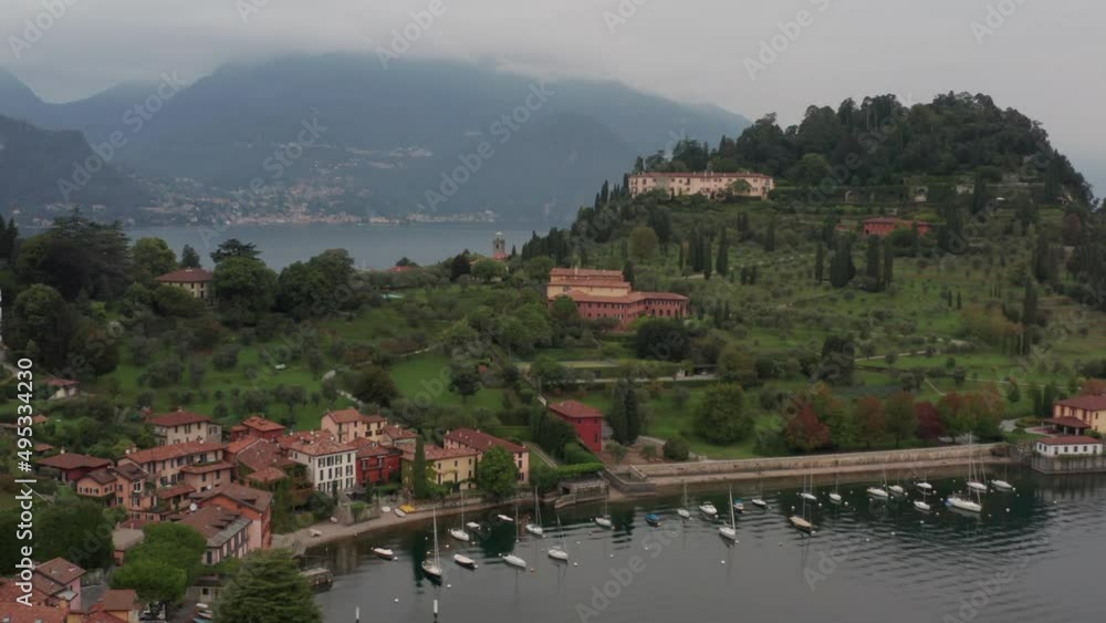 Aerial over green mountain near the city of Bellagio, Italy and revealing a vast and stunning lake Aerial over green mountain near the city of Bellagio, Italy and revealing a vast and stunning lake