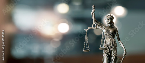 Legal and law concept. Statue of Lady Justice with scales of justice and wooden judge gavel on wooden table. Panoramic image statue of lady justice. © NAMPIX