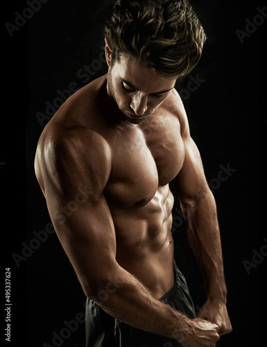 Ripped. Muscular young man showing off his defined body.
