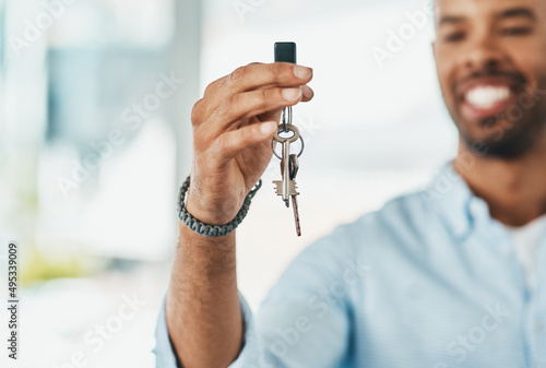 Ive turned the page and started a new chapter. Shot of a young man holding the keys to his new home.