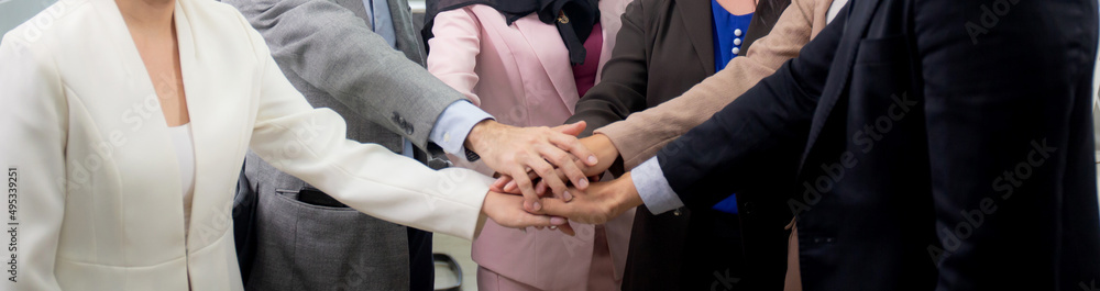 Group of business team harmony with man and woman joining hands stack together in enterprise for victory and success, teamwork of partnership with meeting and cheering, deal and agreement. Group of business team harmony with man and woman joining hands stack together in enterprise for victory and success, teamwork of partnership with meeting and cheering, deal and agreement.