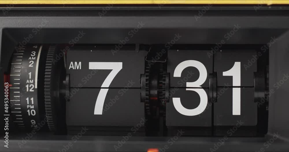 Flip Clock Showing at 7:30 a.m. Spinning on black background. Flip Clock Showing at 7:30 a.m. Spinning on black background.