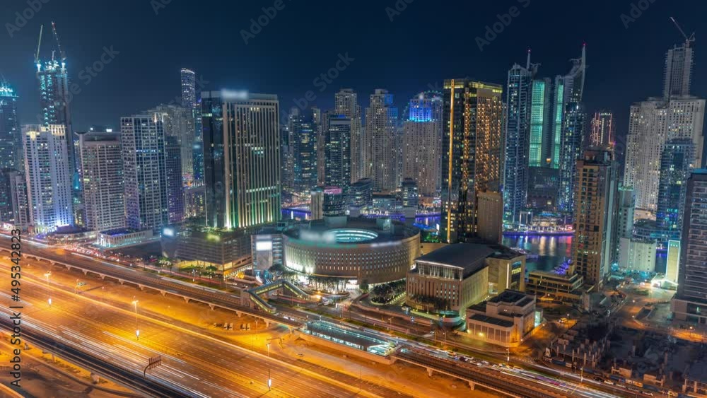 Dubai Marina skyscrapers and Sheikh Zayed road with metro railway aerial night timelapse, United Arab Emirates Dubai Marina skyscrapers and Sheikh Zayed road with metro railway aerial night timelapse, United Arab Emirates