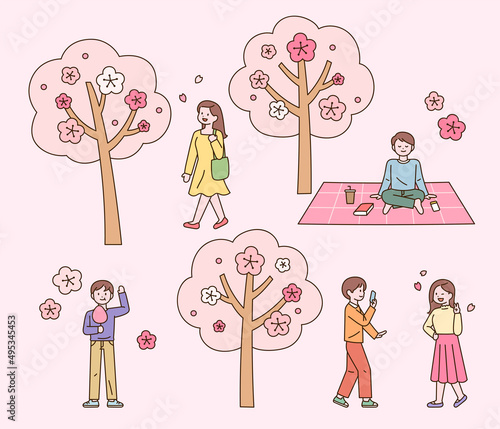 People are enjoying leisure in the cherry blossom park. flat design style vector illustration.