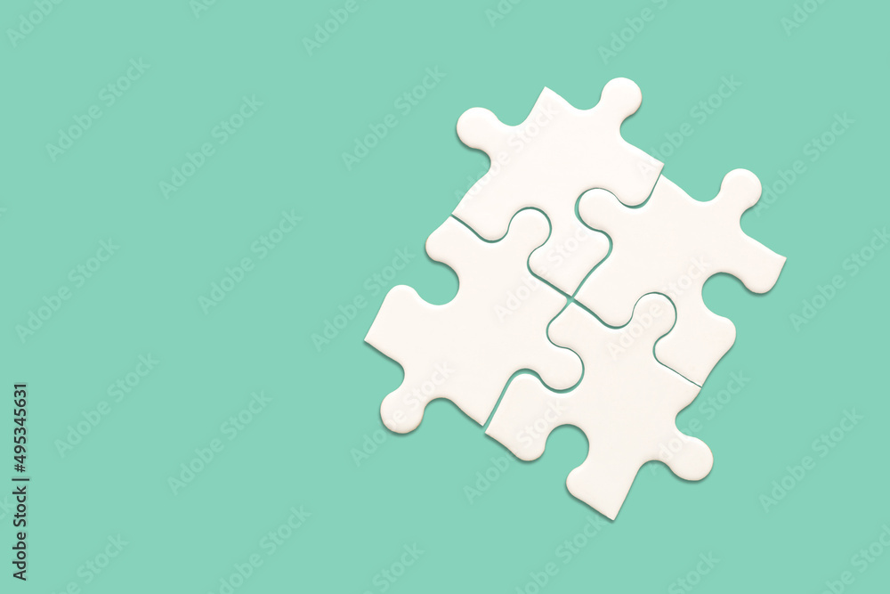 White jigsaw puzzle on green background, Find the right joined team and fit correctly concept White jigsaw puzzle on green background, Find the right joined team and fit correctly concept