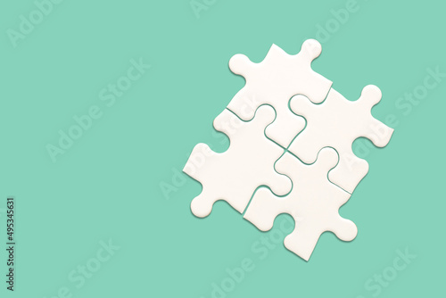 White jigsaw puzzle on green background, Find the right joined team and fit correctly concept