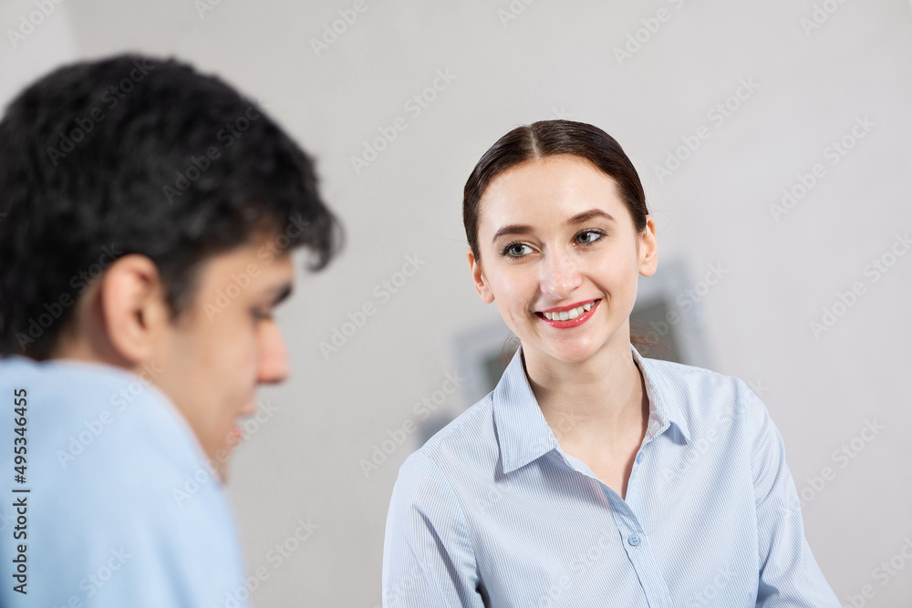 portrait of a young attractive woman discussing documents with a colleague portrait of a young attractive woman discussing documents with a colleague