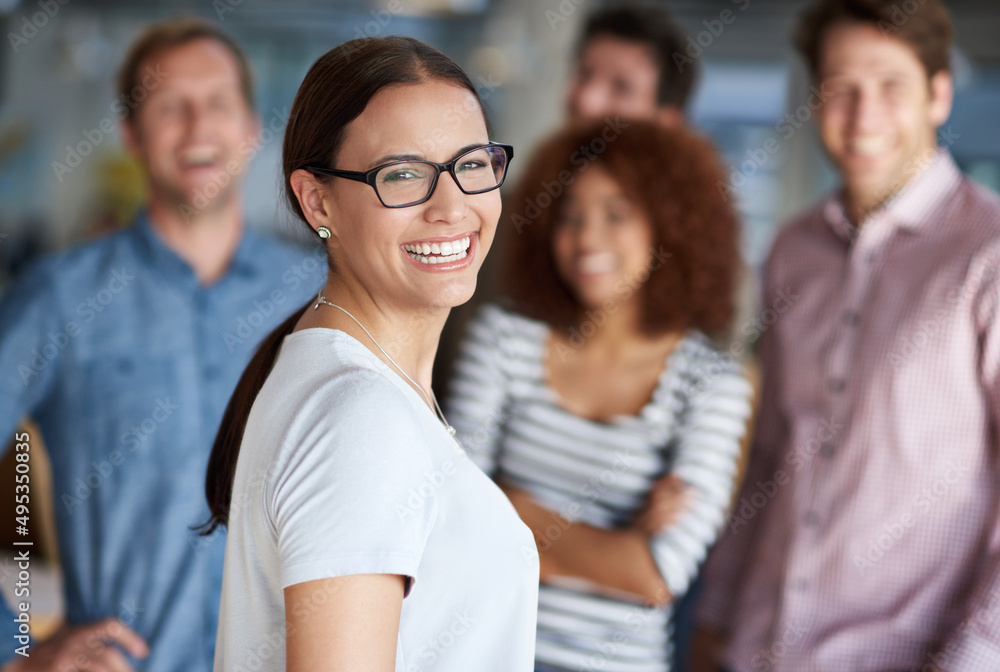 Our office works runs great staff. Beautiful businesswoman smiling with friendly coworkers in the background. Our office works runs great staff. Beautiful businesswoman smiling with friendly coworkers in the background.