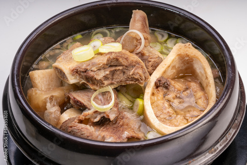 Beef bone marrow soup or Seolleongtang in hot iron pot, Beef Stock Bone, Marrowbone soup in hot iron pot Korean traditional food.