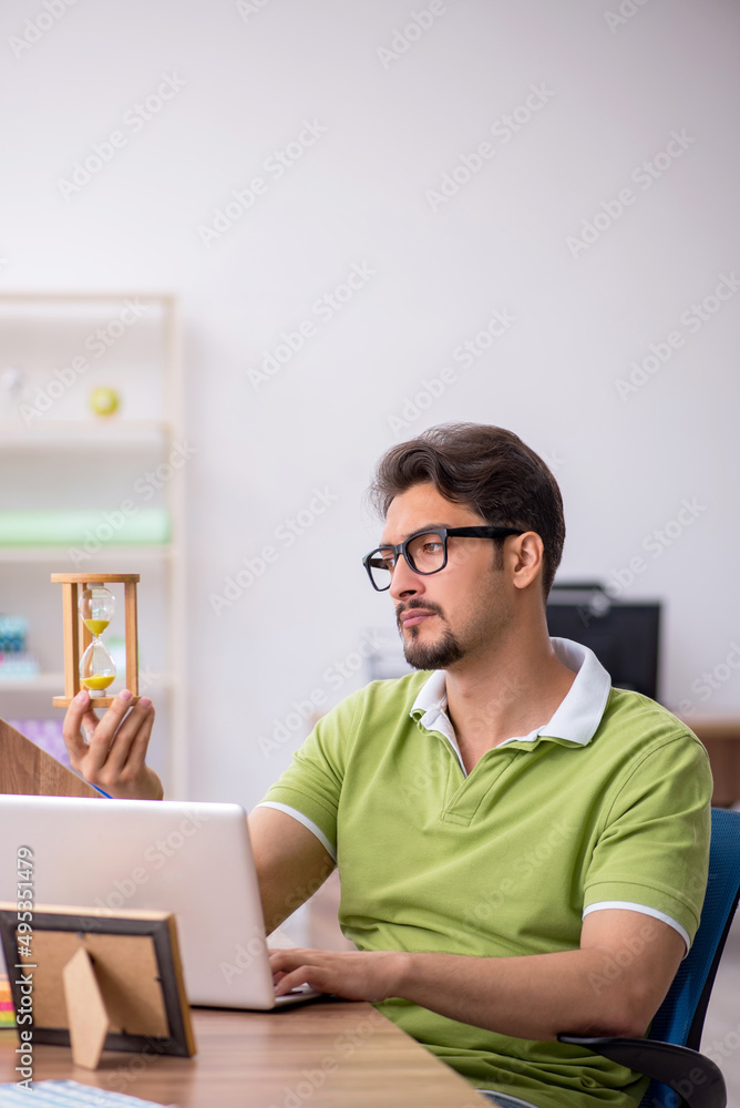 Young male designer working in the office Young male designer working in the office