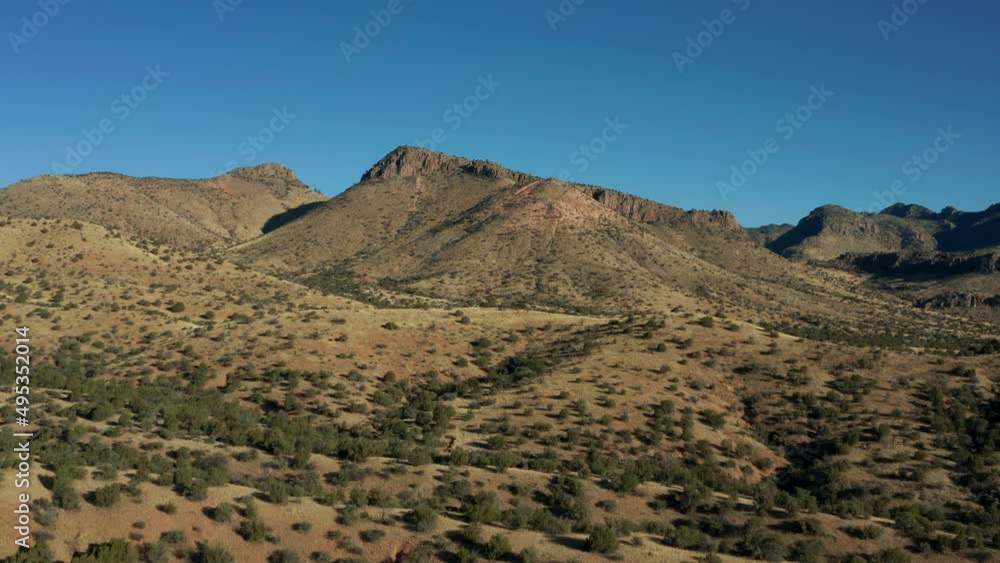 Aerial view of desert landscape saddle with arid mountains behind, 4K Aerial view of desert landscape saddle with arid mountains behind, 4K