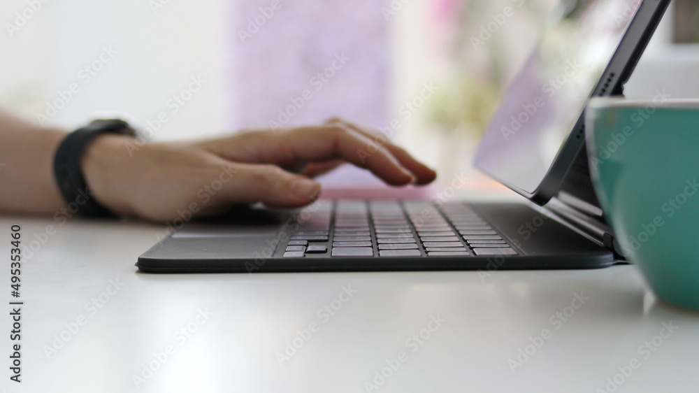 Woman sitting in the morning doing work with a laptop Woman sitting in the morning doing work with a laptop
