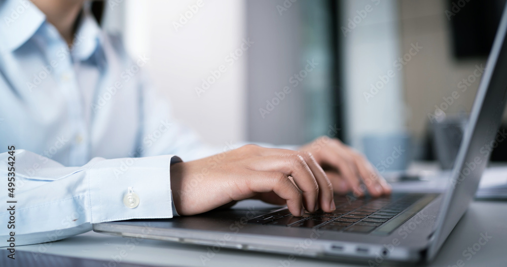Asian Woman working by using a laptop computer Hands typing on keyboard. Working at office professional investor working new start up Asian Woman working by using a laptop computer Hands typing on keyboard. Working at office professional investor working new start up
