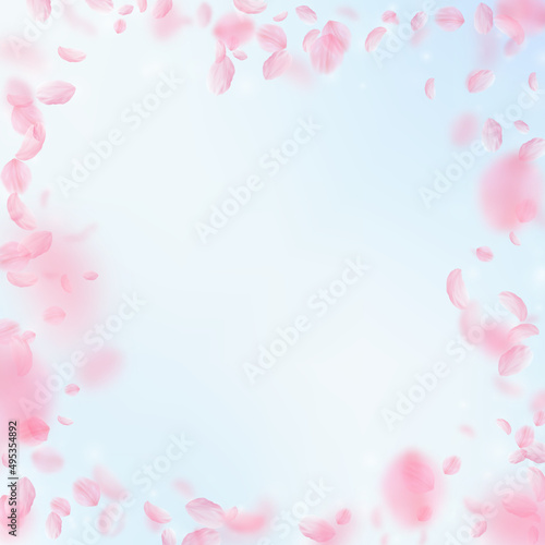 Fototapeta Naklejka Na Ścianę i Meble -  Sakura petals falling down. Romantic pink flowers frame. Flying petals on blue sky square background. Love, romance concept. Nice wedding invitation.