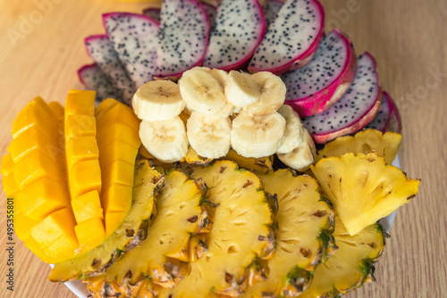 Vietnamese asia fruits: pineaple, banana, dragon fruit, mango. Fresh, jucie and very tasty. photo