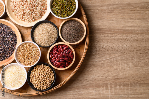 Various cereal, grain, bean, legume and seed in bowl on wooden background, Food ingredients, Table top view © nungning20