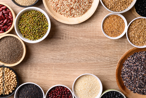 Various cereal, grain, bean, legume and seed in bowl on wooden background, Food ingredients, Table top view