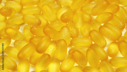 Organic supplements vitamins yellow capsules Omega 3 or D-3 pills, macro shot. Dietary supplement, close up
